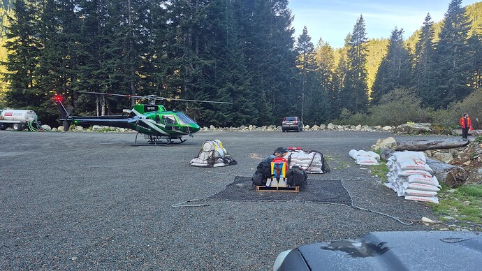 Green helicopter in the staging area at the new expanded parking lot at the base of trail.