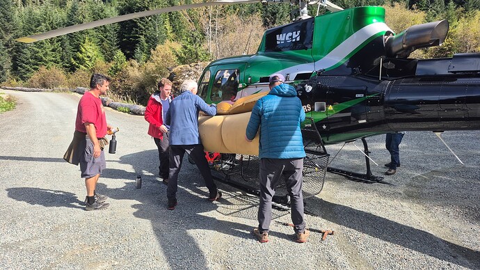 Chris, Sean, Ray, and Jim load the helicopter.