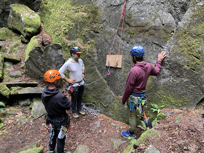 Ben (left) and Tyler (far right) discussing anchors on Jordan’s (center) practice board.