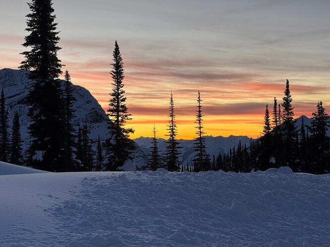 sunset with trees and mountain on the left