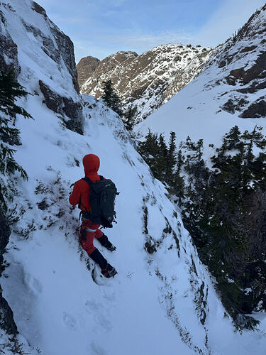 Climber traversing to the lower gully